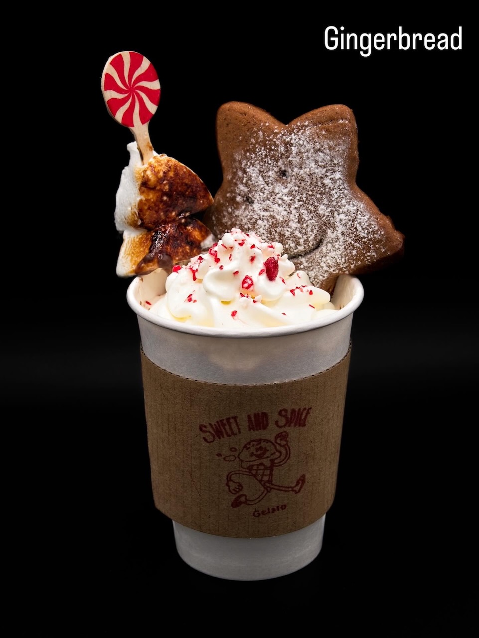 Hot chocolate topped with whipped cream and gingerbread cookies